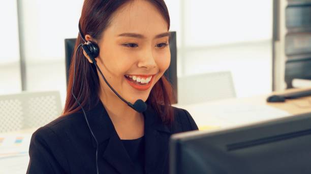 istock Business people wearing headset working in office 1305574996