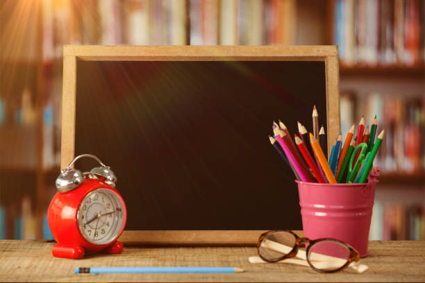 istock Composite image of slate with desk organizer and alarm clock by eyeglasses 1305576489