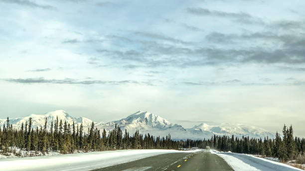 istock Winter Road and in Alaska With Mountains 1305579317
