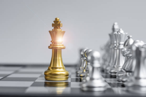 istock Gold Chess king figure on Chessboard against opponent or enemy. Strategy, Conflict, management, business planning, tactic, politic, communication and leader concept 1305583920