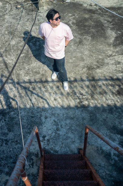 The dangling sneakers create a striking silhouette against the gray backdrop of an overcast day