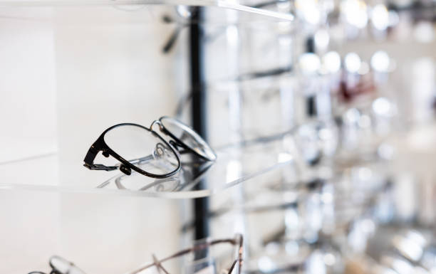 Selective focus at glasses frame on the shelf inside of the store for customer choice and selection. With different color and style. Optometrist and eye vision store or business. Selective focus at glasses frame on the shelf inside of the store for customer choice and selection. With different color and style. Optometrist and eye vision store or business. eye test equipment stock pictures, royalty-free photos & images