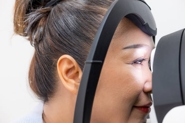 istock Elder Asian women at the Optometry equipment. While optometrist using subjective refraction to  examine eye visual system of elder patient women with professional machine before made glasses. 1305586824
