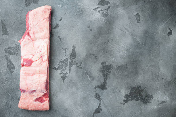 istock Raw beef ribs kalbi, on gray stone background, top view flat lay 1305593955