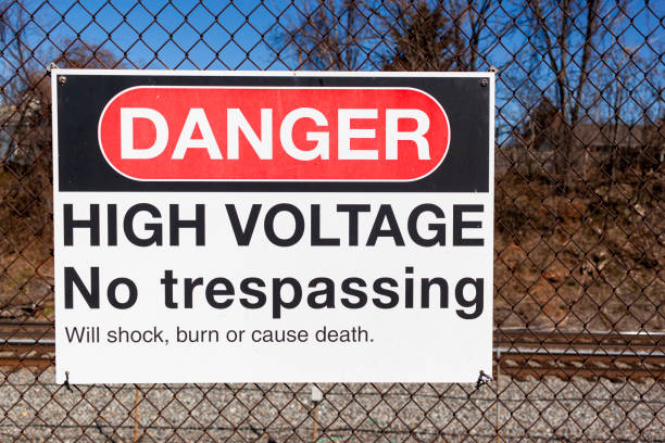 istock Danger High Voltage no trespassing sign by a rail road 1305594723