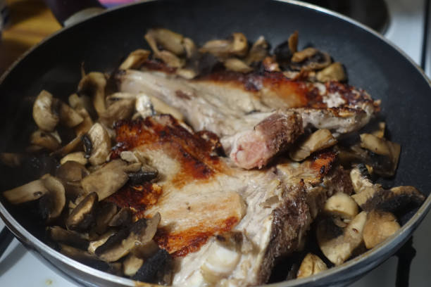 istock Veal chops being cooked with button mushrooms  French cooking 1305600522