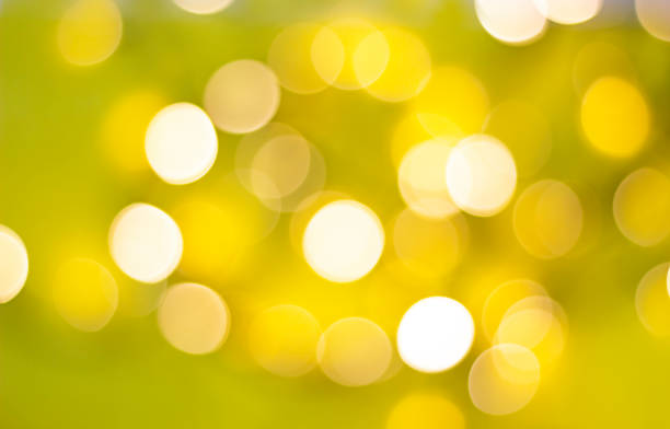 istock Bokeh. Defocused bright lights on yellow-green background 1305601348