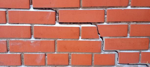 istock The red brick wall cracked. Crack on the red wall. 1305603559