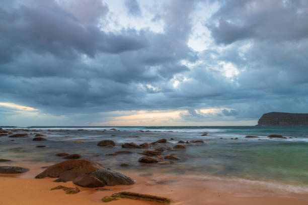 istock Sunrise at the seaside with rain clouds rolling in 1305603637