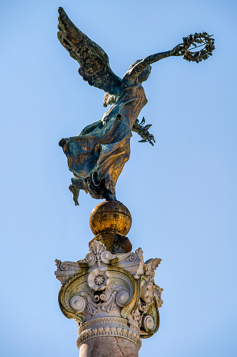 A detail of one of the four bronze statues of the winged victory on the Altare della Patria National Monument in the historic center of Rome near the Capitoline Hill (Campidoglio) and Piazza Venezia, built in 1885 in honor of the first King of Italy, Vittorio Emanuele II. Inside there is the Unknown Soldier grave, the National Memorial Monument dedicated to all Italian soldiers who died in wars. The Altare della Patria is the setting for all the official Italian celebrations, in particular the National Day of the Republic on 2 June and the Liberation Day on April 25th. Image in High Definition format.