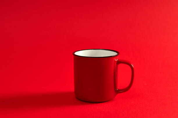 istock Closeup image of one red mug on red background with soft shadow and copy space for promotion. Red cup. 1305608373