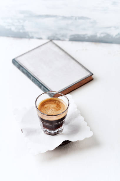 istock Coffee in glass cup on bright wooden background. Copy space. 1305609053