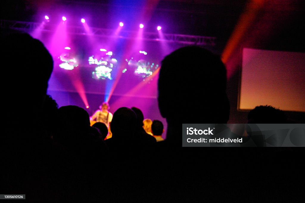 Concert silhouette Hands and people in silhouette during a celebration concert Head Stock Photo