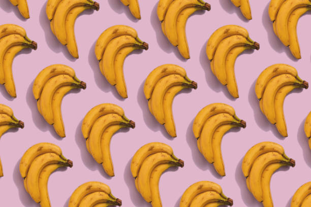 istock Bunch of bananas pattern on pink background, flat lay style minimal 1305612814
