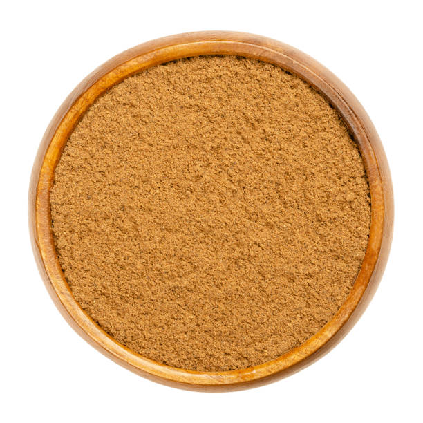 istock Ground nutmeg, powdered nutmeg in a wooden bowl 1305613922