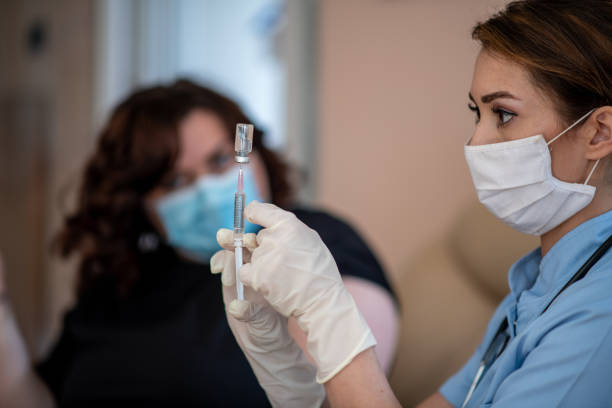 istock Filling up the syringe. Home visit and vaccination during COVID-19 crisis. 1305614006