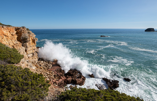 Waves crashing onto rocks on the Algarve Coastline