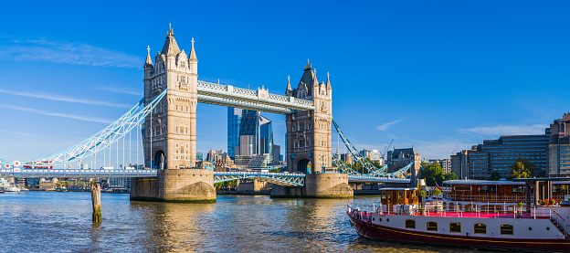 The iconic gothic battlements of Tower Bridge spanning the River Thames in the heart of London, UK.