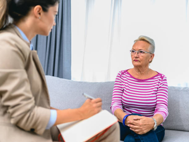 istock Senior woman talks with therapist 1305617755