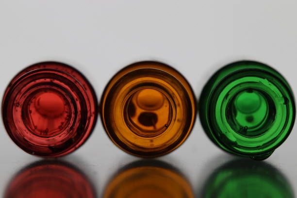 istock Three glass bottles with colored water from above 1305621077