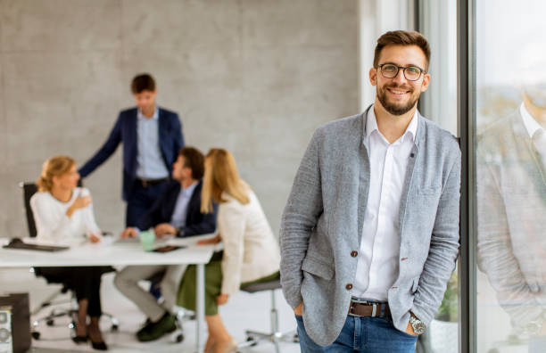istock Handsome young business man standing confident in the office 1305628716