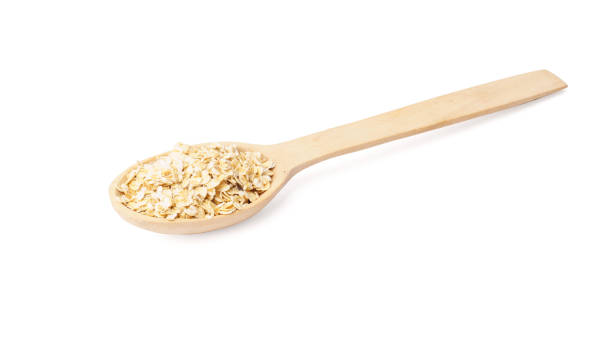 istock oat flakes in wooden spoon isolated on white 1305628983