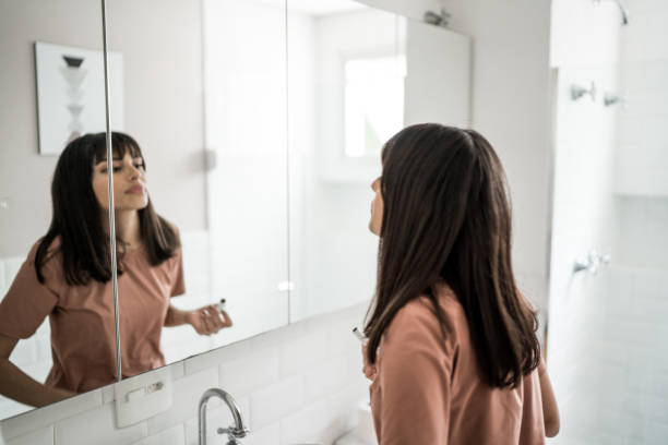 Young woman in the bathroom getting ready for the day