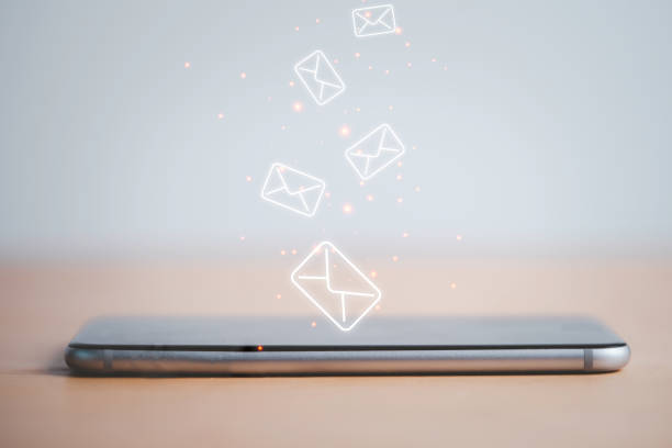 istock Smartphone with virtual letters for receiving and sending e-mail. 1305631213