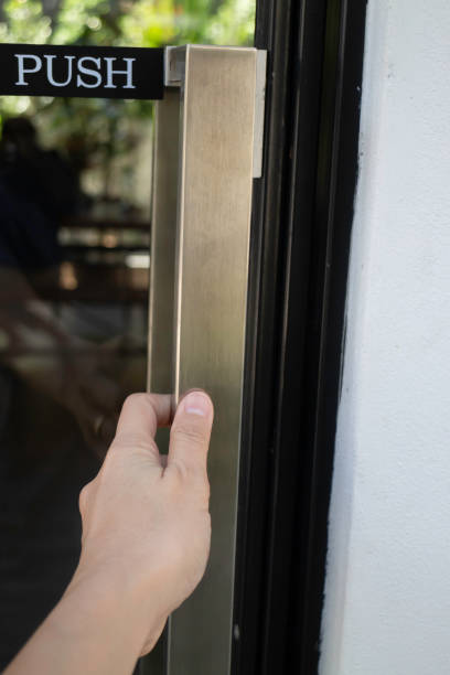 istock Hand on handle door for open to entering restaurant 1305631492
