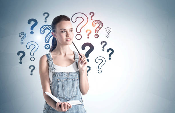 istock Thoughtful young woman and question marks 1305632512