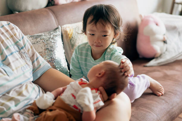 New Asian sister welcoming her brother with affection and love stock photo