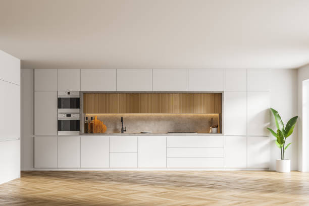 istock Stylish white and wooden kitchen interior with cupboards 1305634179
