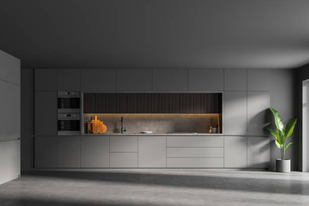 istock Stylish gray and wooden kitchen interior with cupboards 1305634972