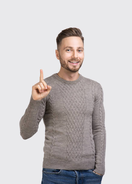 istock Portrait of handsome smiling young man pointing up 1305636152