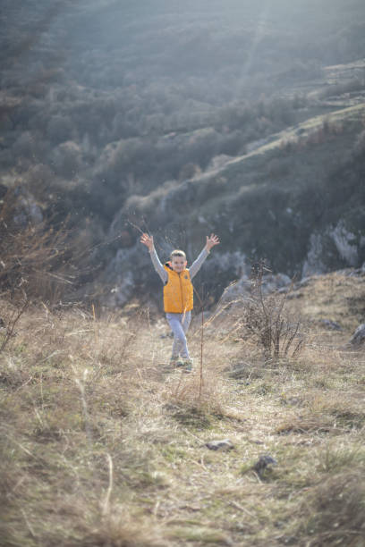 istock Happy boy raising arms 1305637532
