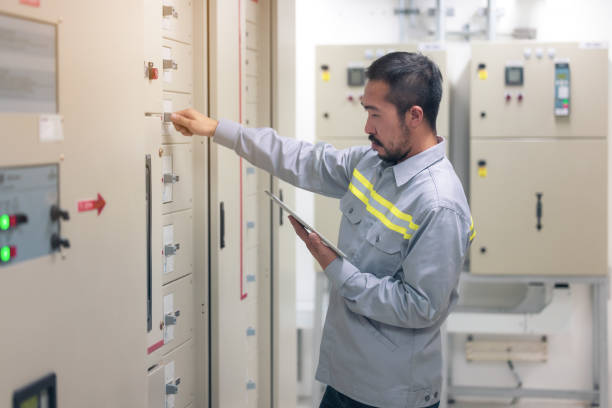 istock Close up hand of engineer or electrician man working check the electrical system with tablet at factory. 1305637538