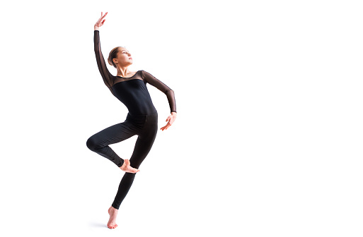 ballet girl in a black tight-fitting suit dances on white background with modern contemporary choreography
