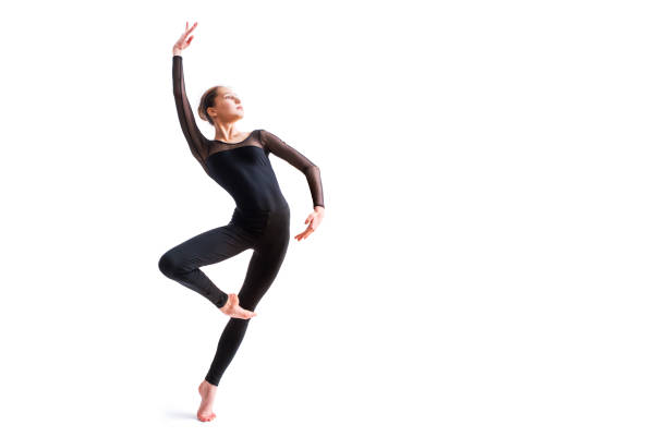 a ballet girl in a black tight-fitting suit dances on a white background with modern contemporary choreography ballet girl in a black tight-fitting suit dances on white background with modern contemporary choreography ballerina stock pictures, royalty-free photos & images