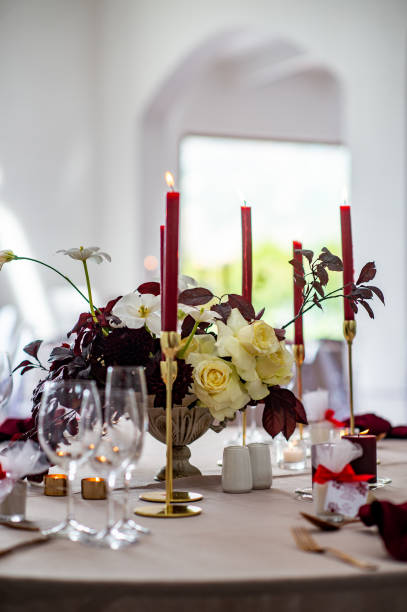 Wedding Table setting with red candles and white roses