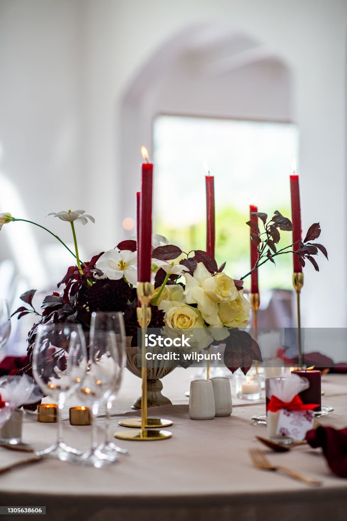 Wedding Table setting with red candles and white roses Indoor Wedding Table setting with red candles and white roses Candle Stock Photo