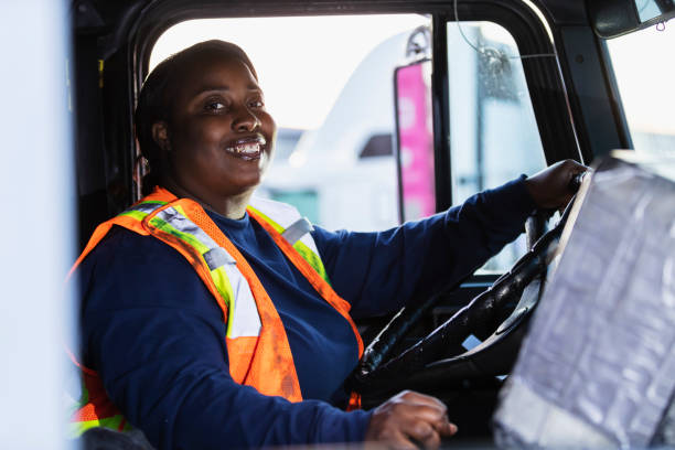 african-american woman driving a semi-truck - truck driver truck trucking semi truck imagens e fotografias de stock