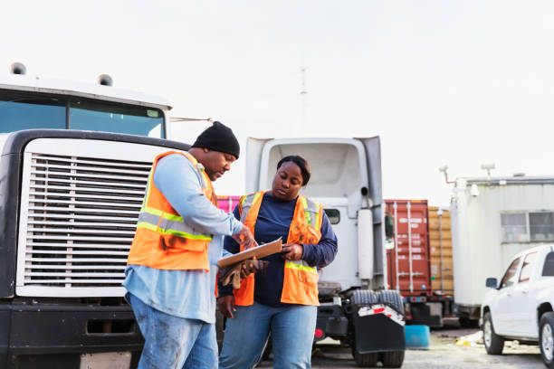 istock Two workers at freight company talking,, with clipboard 1305640713