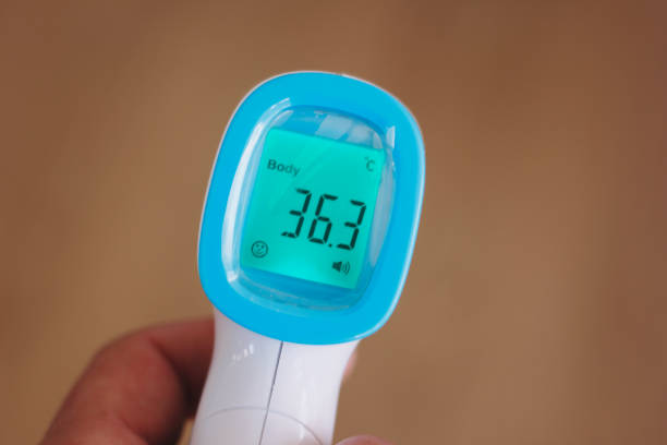 istock screen of electronic temperature meter in man hand 1305641170