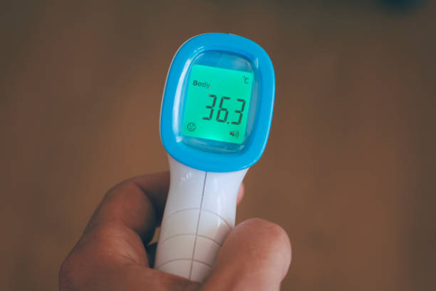 istock screen of electronic temperature meter in man hand 1305641179
