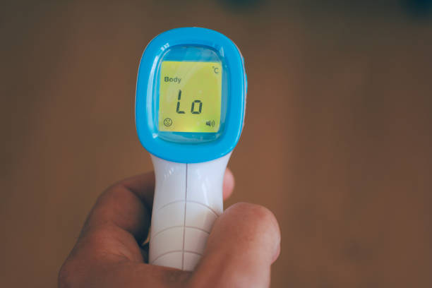 istock screen of electronic temperature meter in man hand 1305641206