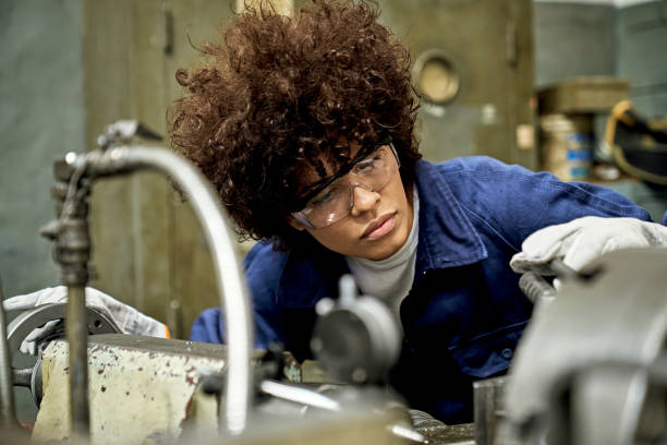 istock Hispanic Female Metal Worker Operating Machinery 1305642447