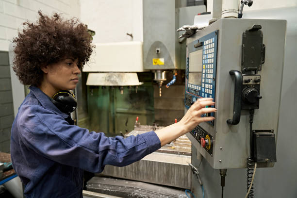 istock Mid Adult Female Foundry Worker Operating Control Panel 1305642472