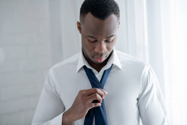 istock A young african american man wearing a tie and looking elegant 1305646213