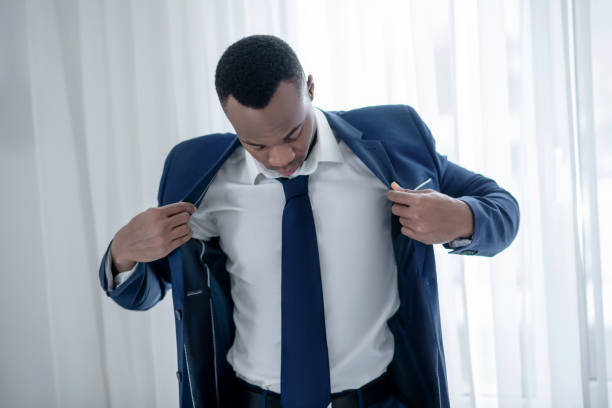 istock A young african american man wearing a jacket and looking elegant 1305646226