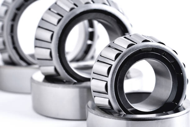 istock roller bearing on a white background close-up, blur as an artistic device, place for copy space 1305647245